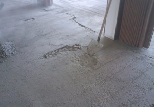 Zprášená a drolící se betonová podlaha